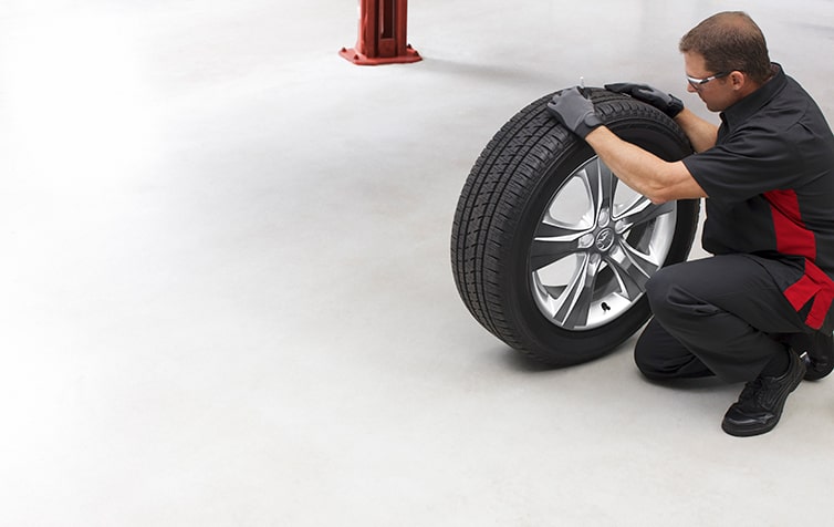 Holden Service Technician Handling a Tyre