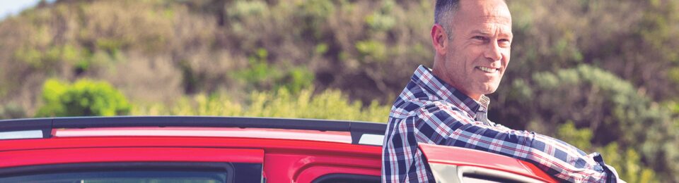 Man Standing Outside of a Vehicle